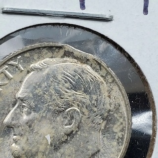 1949 Roosevelt dime clipped planchet error showing curved missing section at the coin edge from incomplete planchet punching